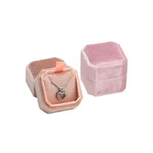 Pink velvet octagonal jewelry box for necklaces and rings, elegant packaging display.