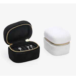 Close-up of portable mini velvet ring jewelry storage box with golden zipper closure details.