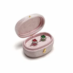 Elegant pink velvet ring box with dual slots, premium jewelry storage and display case.