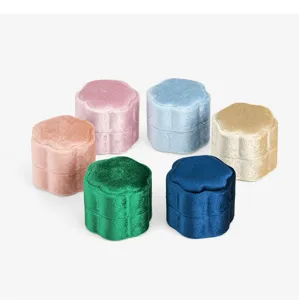 Close-up of portable velvet petal ring boxes in multi-colors, soft jewelry storage display.