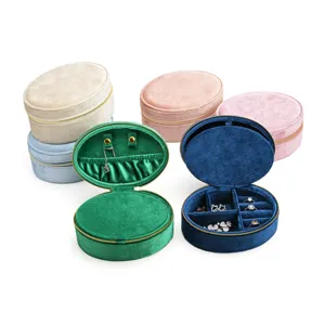 Portable oval velvet jewelry box with zipper, multi-functional ring and earring storage organizer.