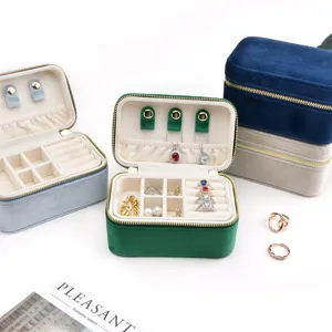 Portable double layer velvet jewelry box with ring rolls and compartments for earrings.