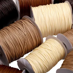 Detail shot of colorful waxed cords, showing various shades and smooth texture for DIY crafts.