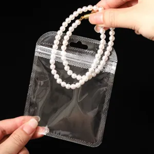 Close-up detail shot of transparent clear ziplock plastic storage bag with pearl accessory.