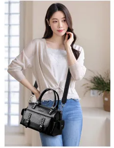 Detail view of the stylish black PU leather shoulder bag with metal hardware and strap.