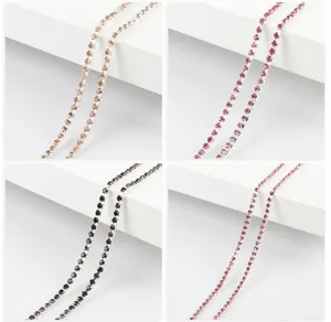Detailed close-up of colorful rhinestone claw chain, dense crystal trim for DIY jewelry.