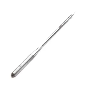 Sewing machine needle detail shot, durable metal sewing needle designed for household treadle machines.