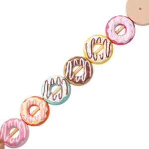 Detailed close-up shot of colorful donut beads on a wooden stick, showing vibrant sprinkles.