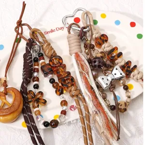 Handmade DIY phone chain charm material pack featuring acrylic leopard amber letter beads and bows.