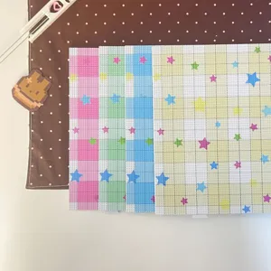 Detailed view of colorful fuse bead pegboards with grid star patterns for DIY crafts.