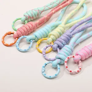 Korean style light colored braided phone lanyard with colorful polka dot spring rings, main view.