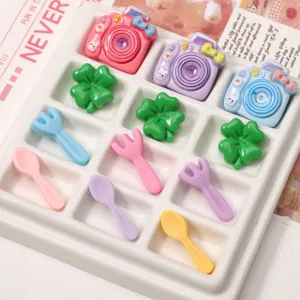 Colorful DIY resin charm set including mini cameras, clovers, and cutlery accessories.