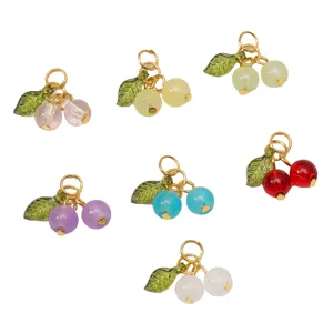 Colorful glass cherry charms with gold rings and green leaves for DIY jewelry making.