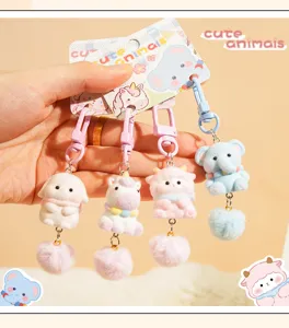 Cute animal plush keychains detail close up, fluffy pom pom pendant and cartoon doll design.