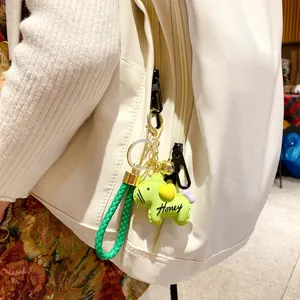 Cute green horse keychain bag charm with braided strap and gold metal hardware for women