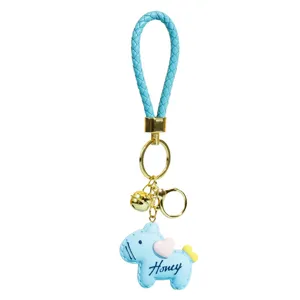 Cute blue braided leather keychain with pony pendant, gold hardware and bell charm.