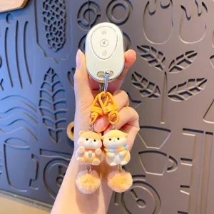 Cute plush puppy twin keychain with fluffy pom poms and electronic remote pendant charm.