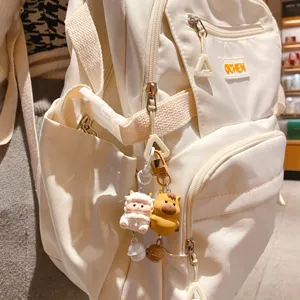 White casual backpack with cute zodiac animal keychains, multi-functional school bag for daily.