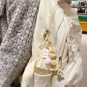 Cute plush animal keychain paired with a stylish casual white backpack for daily use main view