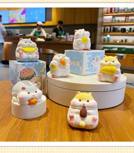 Detailed view of cute fat hamster resin figurines eating food, perfect desktop decor setup.