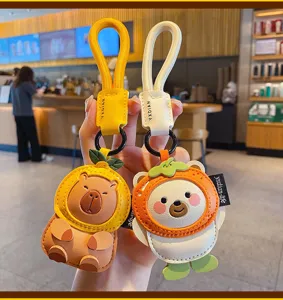 Cute cartoon leather fruit capybara and bear keychain detail, perfect bag charm pendant.