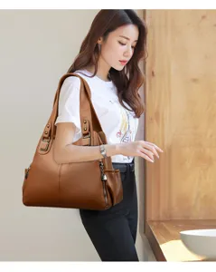 Detailed view of large vintage brown PU leather shoulder bag showcasing soft texture and pockets.