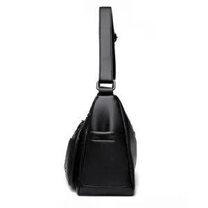Schwarze Ledertasche Seitenprofil Detail mit praktischem Mehrfachtaschen-Design.