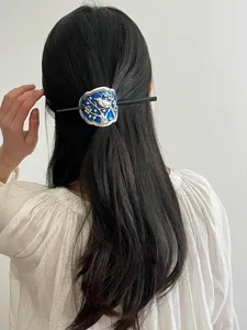 Traditional Chinese cloisonne hair stick detail showing blue enamel bird and branch motif.