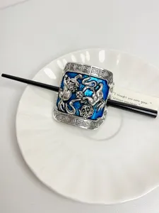 Vintage blue enamel hair stick with traditional animal motif and black pin for women styling.