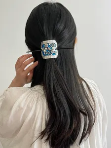 Detailed view of vintage cloisonne hair stick, retro ethnic metal bun holder accessory.