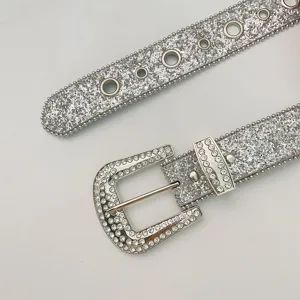 Close-up detail of silver rhinestone buckle and glittering sequin belt for women stylish.