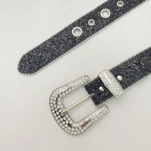 Close-up detail of luxury rhinestone western belt with sparkling glitter strap and crystal buckle.