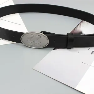 Black leather belt for women with a vintage metal oval buckle, stylish and casual accessory.