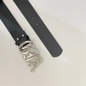 Details of black litchi grain leather belt with vintage Y2K gothic letter metal buckle.