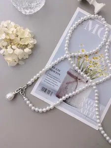 Detailed view of elegant women pearl waist chain decorative strap with metal clasp and pendant.