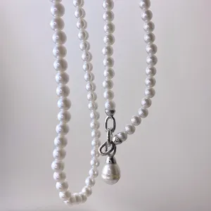 Exquisite pearl chain detail featuring smooth white pearls and silver metal clasp accessory.