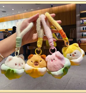 Detail view of cute cartoon plush animal keychains featuring cute capybara and friends.