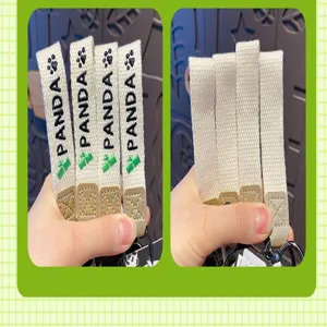Close-up detail of the cute panda themed keychain strap featuring printed logo and metal ring.