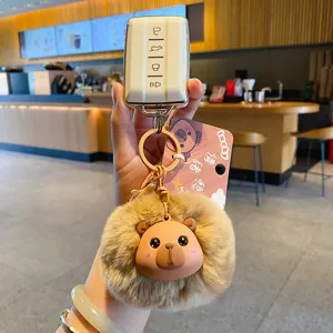 Cute plush capybara keychain with fluffy pom pom and car key case holder for bags and keys.