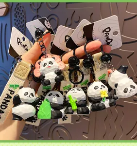 Close-up detail of cute resin panda keychains featuring various styles like bamboo and flowers.