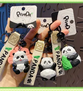 Resin wood-carved panda keychain detail, cute creative bamboo-holding animal bag pendant.