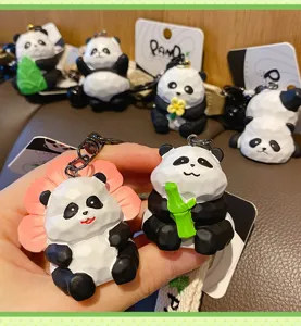 Cute resin wood-carving style panda keychain, creative bamboo holding panda bag pendant.