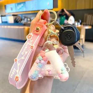 Acryl flüssiger Buchstabe Schlüsselanhänger mit bunten Kugeln und rosa Schlaufe für Taschen.