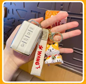 Close-up detail of cute cartoon puppy keychain with protective car key case and strap.