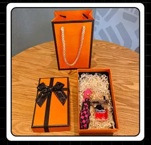 Detailed view of cute cartoon oil-injected keychain set with luxury gift box and bag packaging.