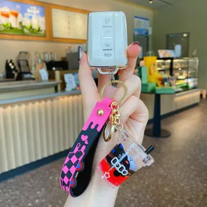 Cartoon oil drifting cat keychain with white car key case, trendy pink and black strap.