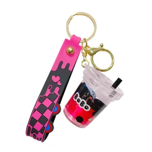 Cute liquid glitter boba cup keychain with pink checkerboard strap for car keys and bags.