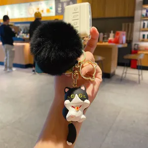 Cute cartoon cat keychain with black fluffy pom pom and white car key case for women accessory.