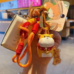Cute chubby dog keychain with woven rope strap, creative resin cartoon animal charm for bag.
