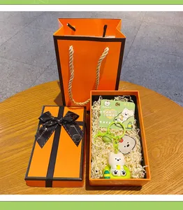 Cute West Highland Terrier keychain set in orange gift box, perfect couple bag accessory.